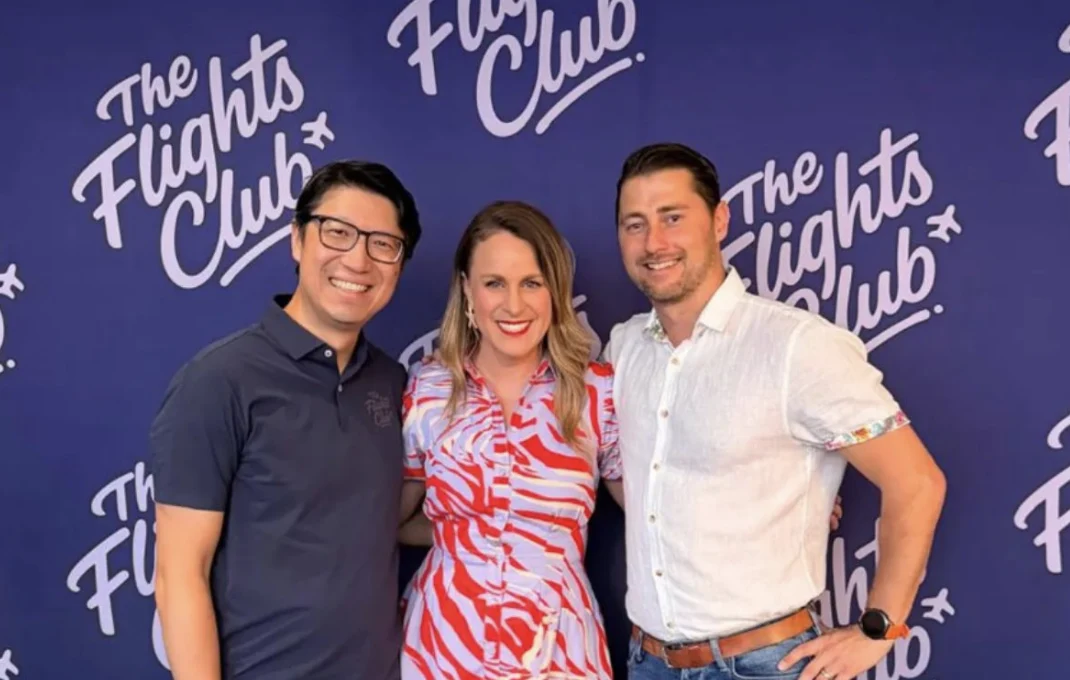Three people together in front of The Flights Club event backdrop